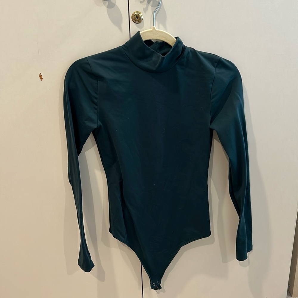 Turtleneck emerald green bodysuit.